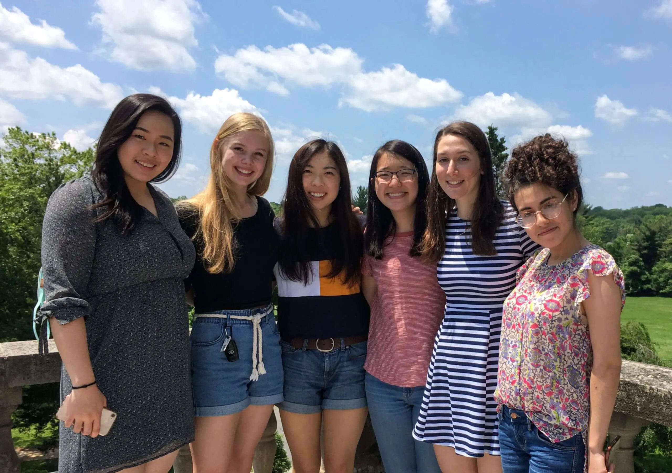 Group of Wilberforce School Alumni pose for a photograph together on a balcony.