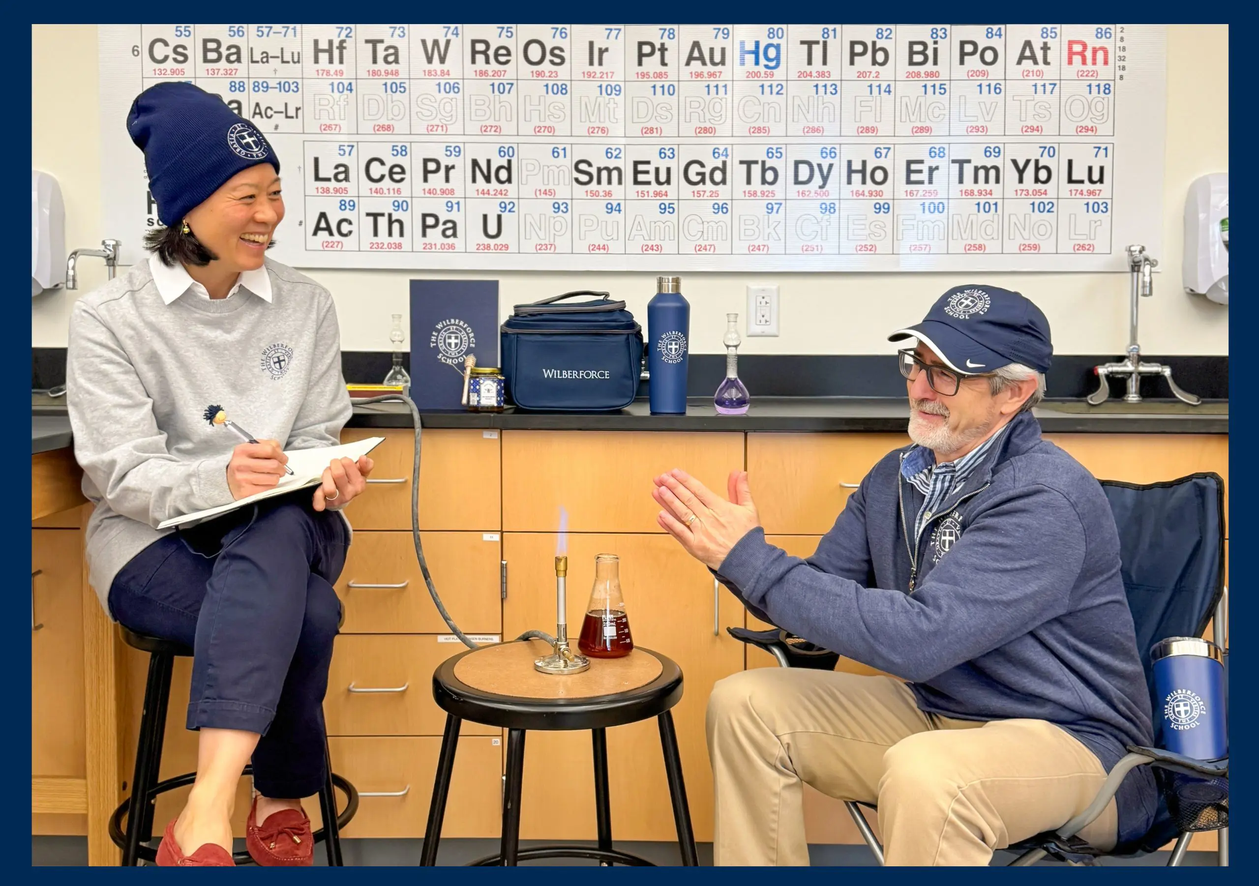 Teachers wearing Wilberforce School branded clothing in a science classroom.